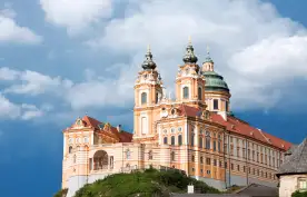 A distant view of Melk abbey on a rocky outcrop above the Danube river, Austria