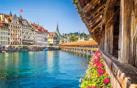 Famous Chapel Bridge in the historic city center of Lucerne, the city's symbol and one of Switzerland's main tourist attractions and views on a sunny day in summer, Canton of Lucerne, Switzerland