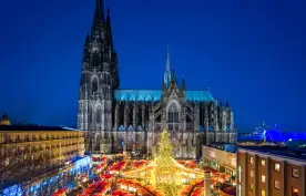 Christmas market and Catholic cathedral at night in the city of Cologne, Germany