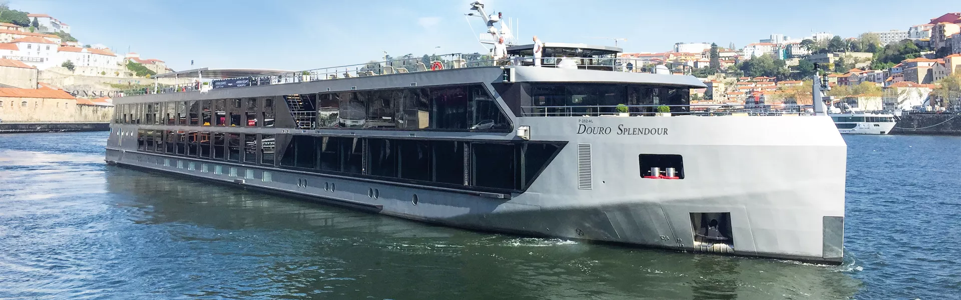 Riviera river cruise ship sailing past vineyards on the Douro River
