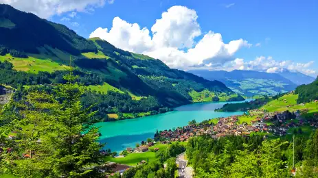 A scenic view or Swiss countryside as seen from a passing train