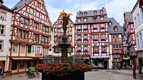 Beautiful Market Square with fountain, flowers and half timbered buildings in Bernkastel-Kues, Germany