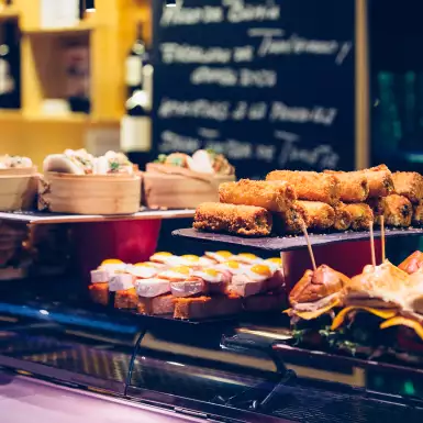 Several trays presented with a variety of Spanish tapas on the bar counter