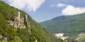 Rheinstein Castle partially concealed by the surrounding forests, on a valley leading down to River Rhine