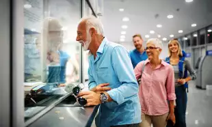 A happy elderly couple validating tickets at an airport