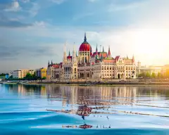 The Hungarian Parliament building over the Danube river at sunset in Budapest, Hungary