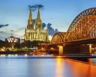 Cologne Cathedral and Hohenzollern bridge illuminated in Cologne, Germany