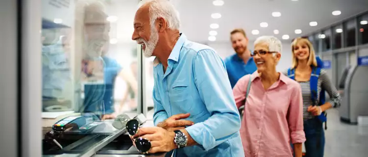 A happy elderly couple validating tickets at an airport